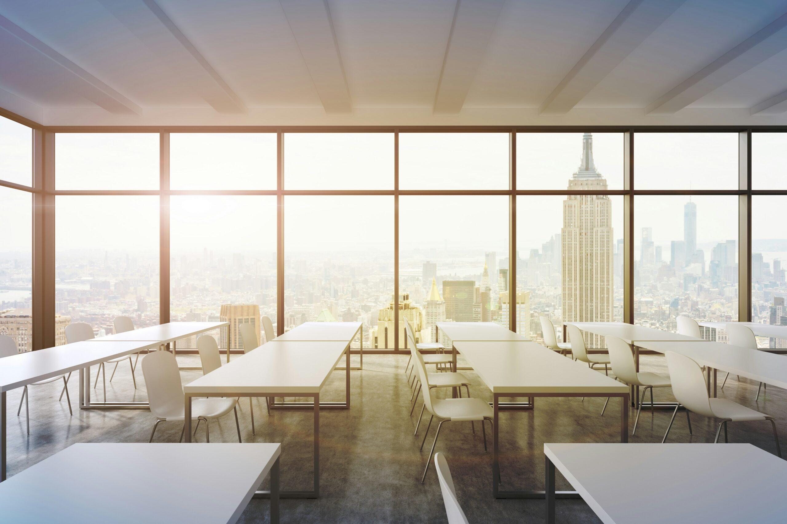 Empty conference room featuring a large window with a view of the city skyline.